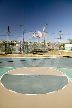 Basketball hoop and court in El Paso Texas looking toward Juarez, Mexico photo