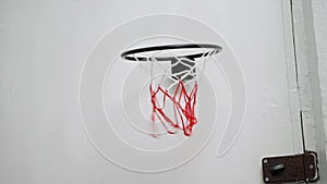 Basketball hoop on the door of the room. the basketball hits the basket. home games, recreation. successful hit on the target.