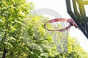 Basketball hoop on the fresh air against the green trees