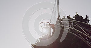 Basketball, hoop and net at outdoor court or park for game, shot or score point in match. Ball ring in sunshine for