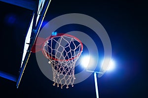 Basketball hoop on outdoor court at night