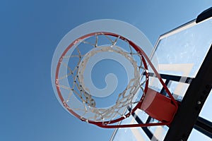 Basketball hoop photographed from below on a beautiful summer day