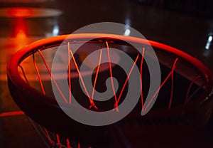 basketball hoop in red neon lights in sports arena during game