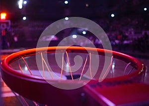 basketball hoop in red neon lights in sports arena during game