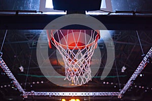 basketball hoop in red neon lights in sports arena during game