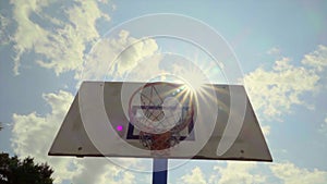 Basketball hoop and sun, slow motion