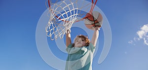 Basketball kids training game. Basketball school for little child boy. Banner isolated on sky background.