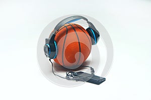 Basketball listing music with headphone and smartphone.