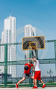 Basketball match. Playing ball with a black ball wearing red, grey and white colors