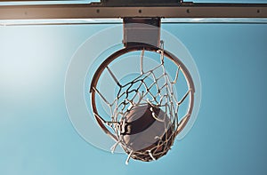 Basketball, net and ball below in sports game outdoors for sports match in the USA. Sport and airball of throw to score