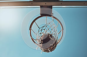 Basketball, net and ball below in sports game outdoors for sports match in the USA. Sport and airball of throw to score