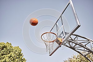 Basketball net, ball and outdoor sports goals, competition game and action on sky background. Background basketball