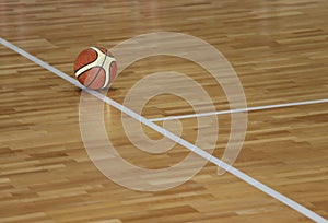 basketball on the parquet of basketball court