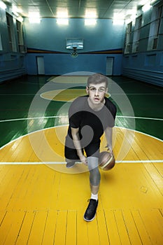 Basketball player in action in a basketball court