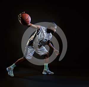 Basketball player with ball, practicing in action