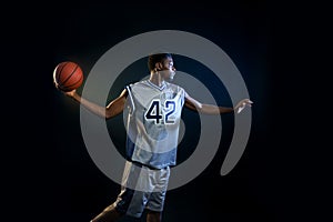 Basketball player with ball, practicing in action