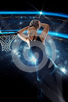 Basketball player in black jersey makes a slam dunk in the game