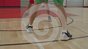 Basketball player dribbling the ball in motion