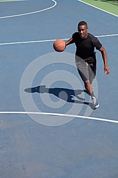 Basketball Player Dribbling photo