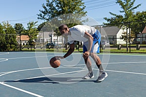 Basketball Player Dribbling photo