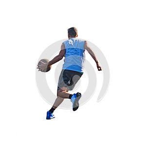 Basketball player dribbling to the basket