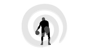 Basketball player fills the ball. Slow motion. Silhouette. White background