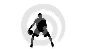 Basketball player fills the ball. Slow motion. Silhouette. White background