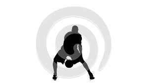 Basketball player fills the ball. Slow motion. Silhouette. White background