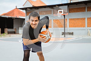 a basketball player holding a basketball in a pose holding the ball while dribbling