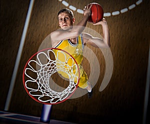 Basketball player making slam dunk on basketball arena