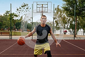 Basketball player in motion on outdoor court