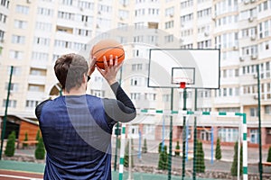 Basketball player at an outdoor stadium trains with a ball