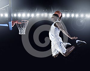 Basketball Player scoring a slam dunk basket