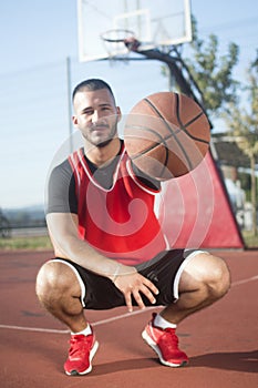 Basketball player showing basketball ball