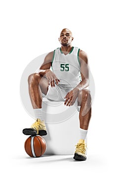 Basketball player sitting resting. Professional basketball player sitting in white background