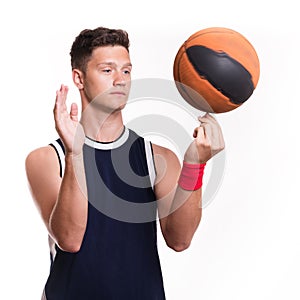 Basketball player spins the ball on his finger