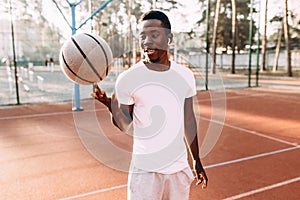 Basketball player spins a basketball, morning training at the stadium