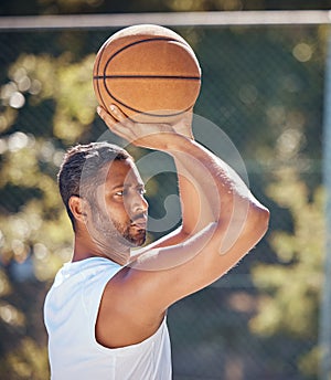 Basketball player, sports and training with fitness man with ball ready to shoot or throw while playing at an outdoor