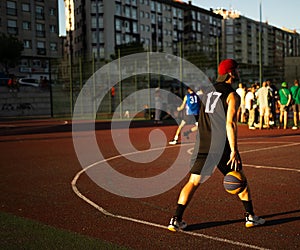 Basketball player training on a court outdoors in summer days- 3x3 red cap