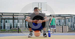 Basketball player using mobile phone 4k