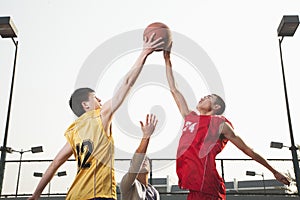 Basketball players fighting for a ball