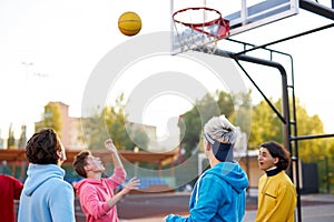 Basketball players outdoors. summer vacation, holidays, games and friendship concept