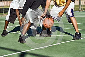 Basketball players playing in court