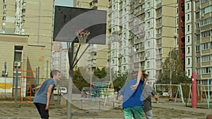Basketball players playing streetball game on court