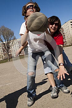 Basketball players scrimmage at street