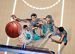 Four basketball players during scrimmage photo