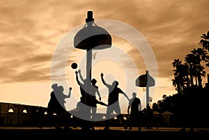 Basketball players at sunset