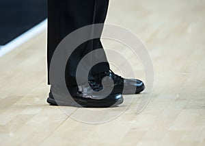 Basketball referee shoes on the floor in the gym