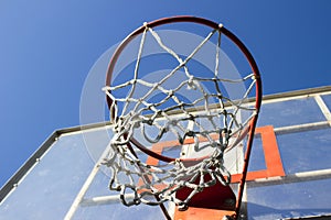 Basketball ring and board with white net.