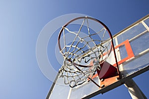 Basketball ring and board with white net.